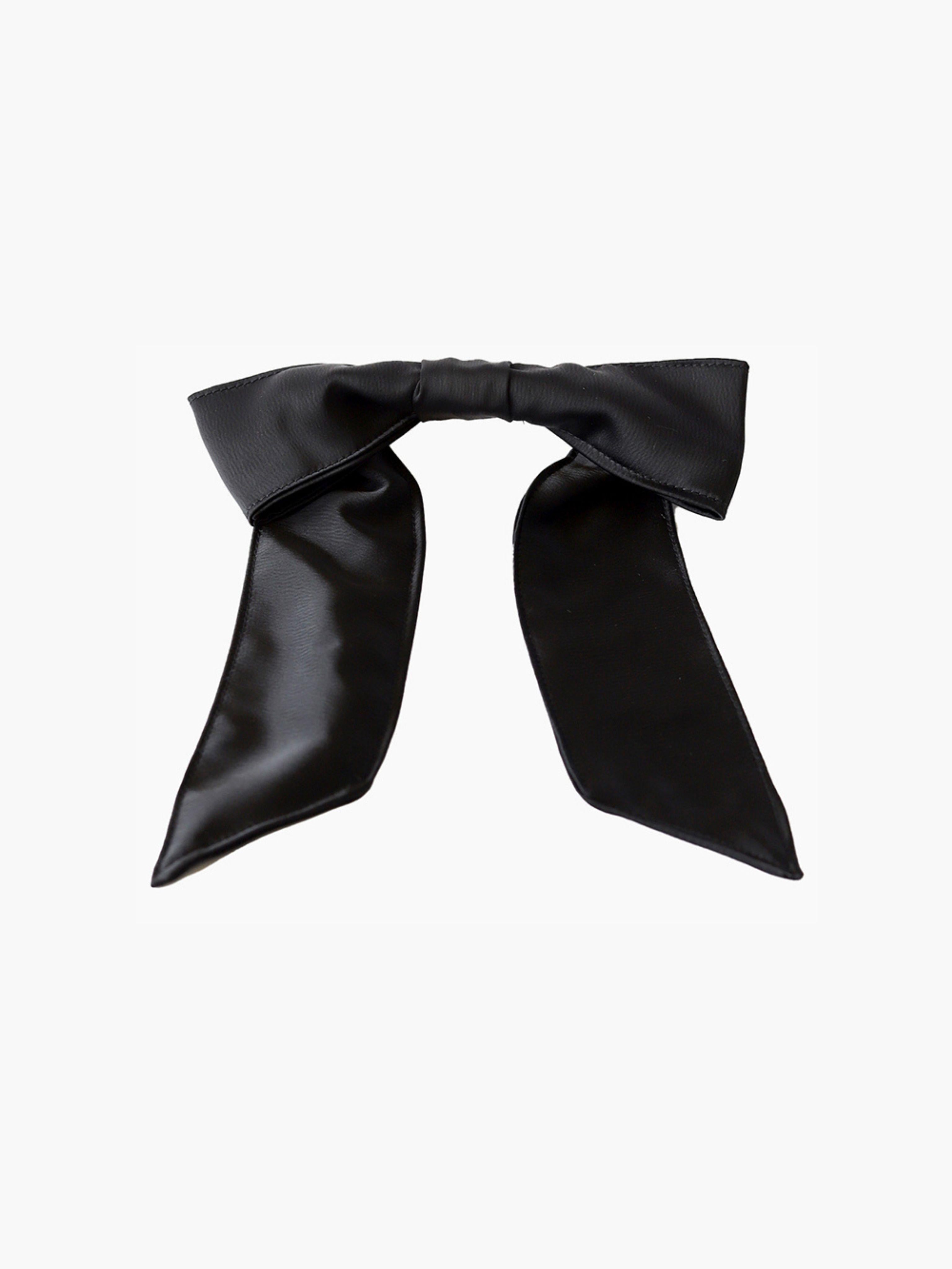 Black satin hair bow clip accessory on a white background