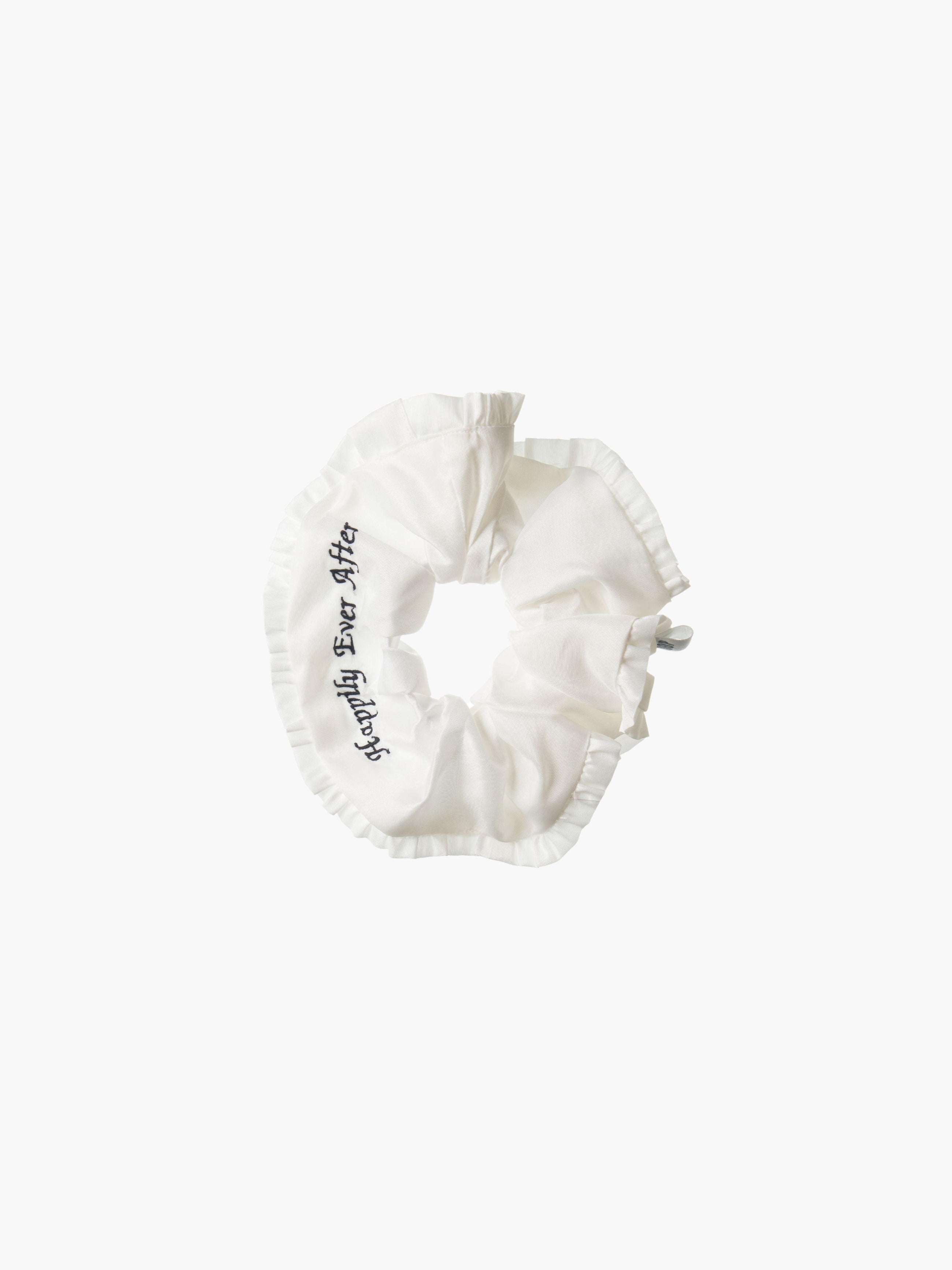 Ivory ruffled scrunchie with black embroidery that reads 'happily ever after' on a white background