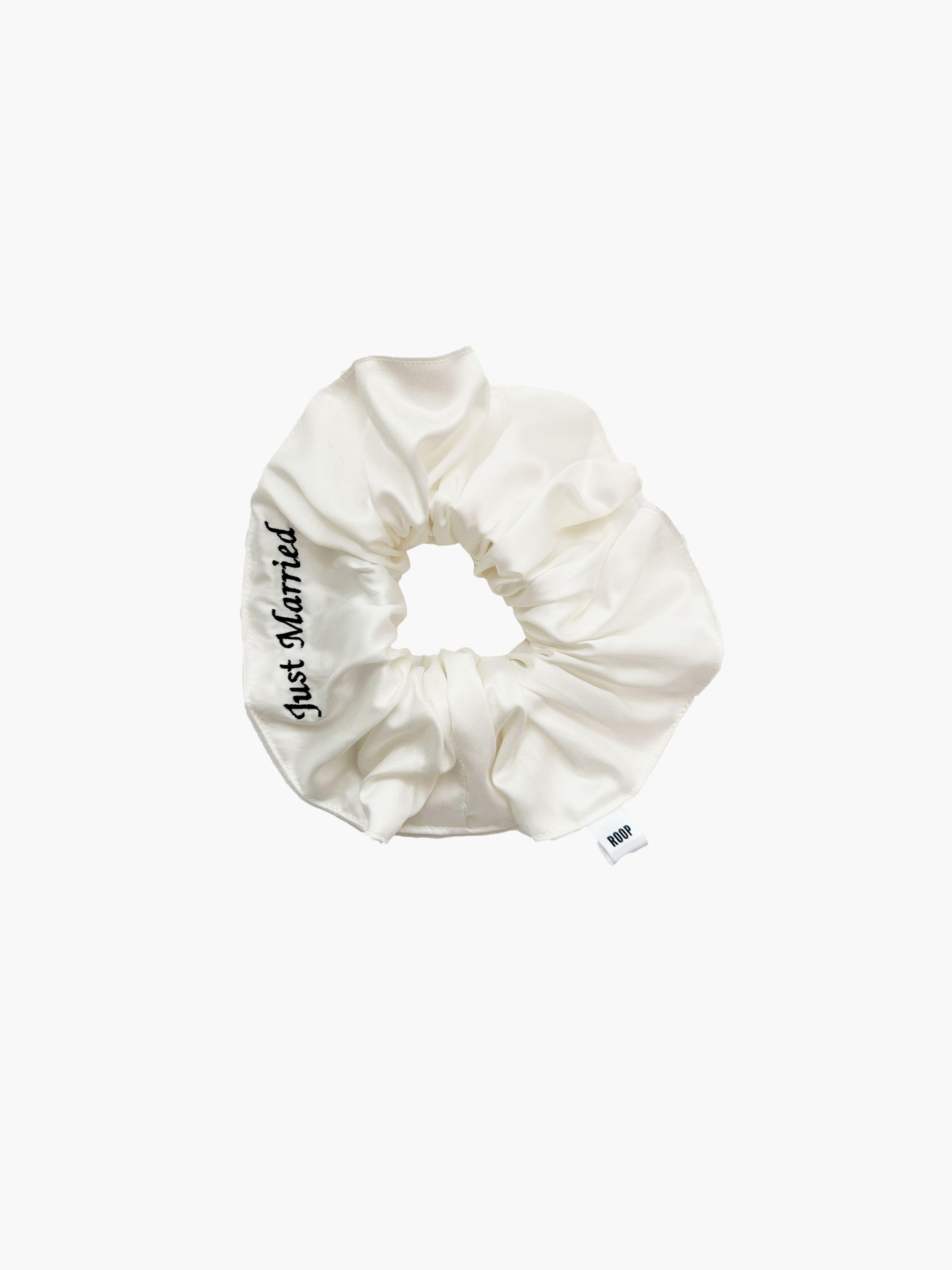 Ivory bamboo silk satin scrunchie with 'Just Married' embroidered in black on a white background.