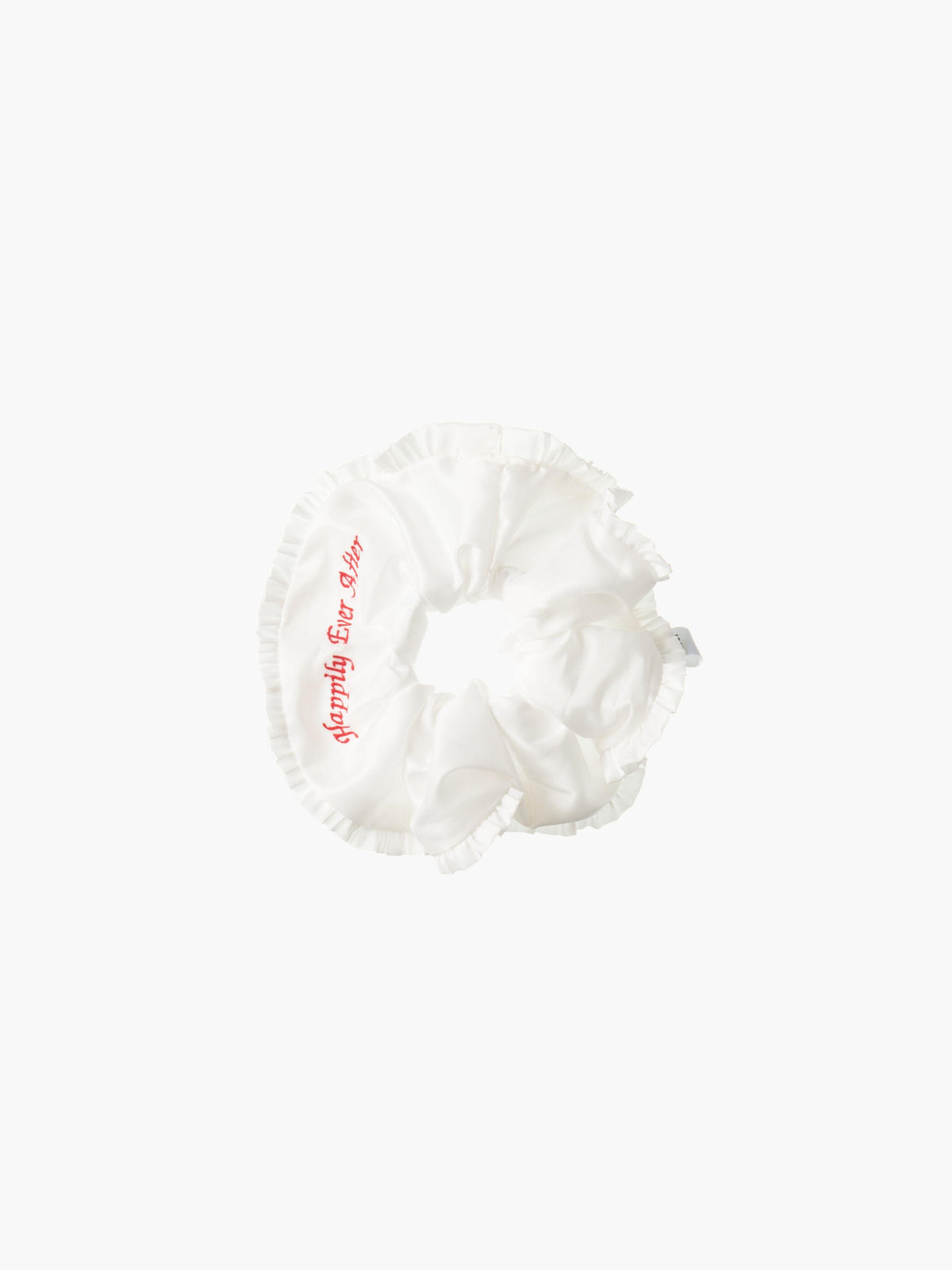 Ivory ruffled scrunchie with red embroidery that reads 'happily ever after' on a white background