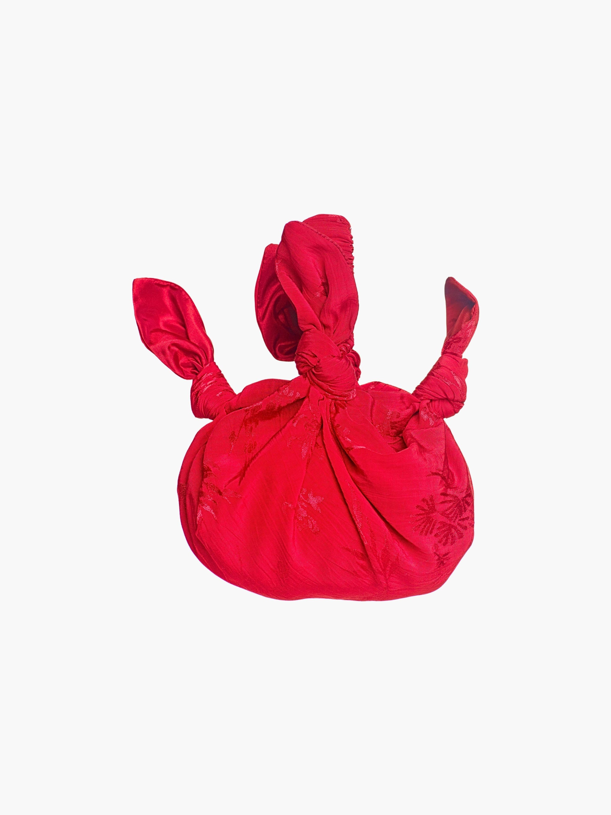 rd floral satin knotted handbag on a white background