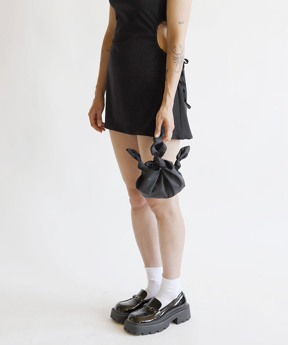 Model holding Baby furoshiki handbag in deadstock black taffeta