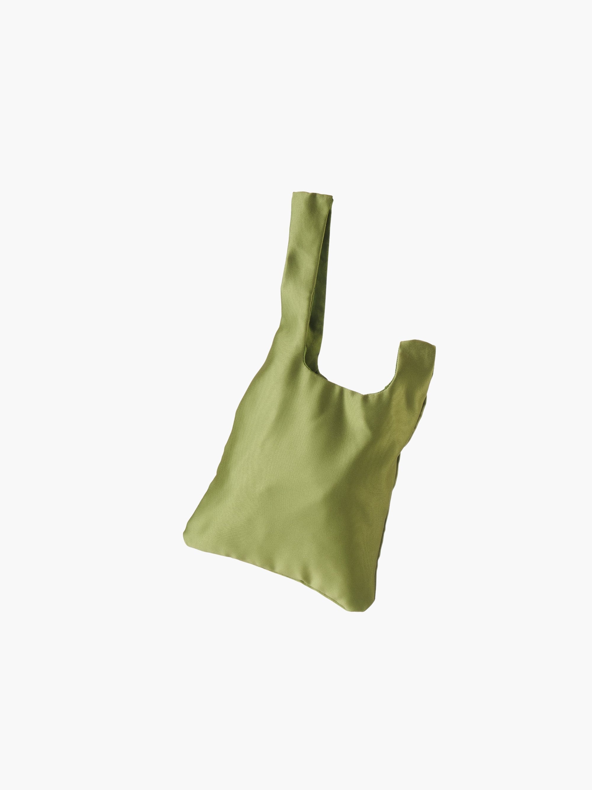 Green satin knot bag against a plain white background. The elegant bag has a twisted handle and sleek, glossy fabric, exuding a chic, minimalist style.