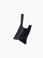 Black satin knot bag against a plain white background. The elegant bag has a twisted handle and sleek, glossy fabric, exuding a chic, minimalist style.