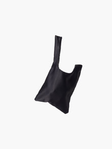 Black satin knot bag against a plain white background. The elegant bag has a twisted handle and sleek, glossy fabric, exuding a chic, minimalist style.