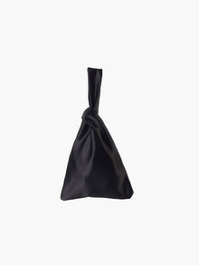 Black satin knot bag against a plain white background. The elegant bag has a twisted handle and sleek, glossy fabric, exuding a chic, minimalist style.