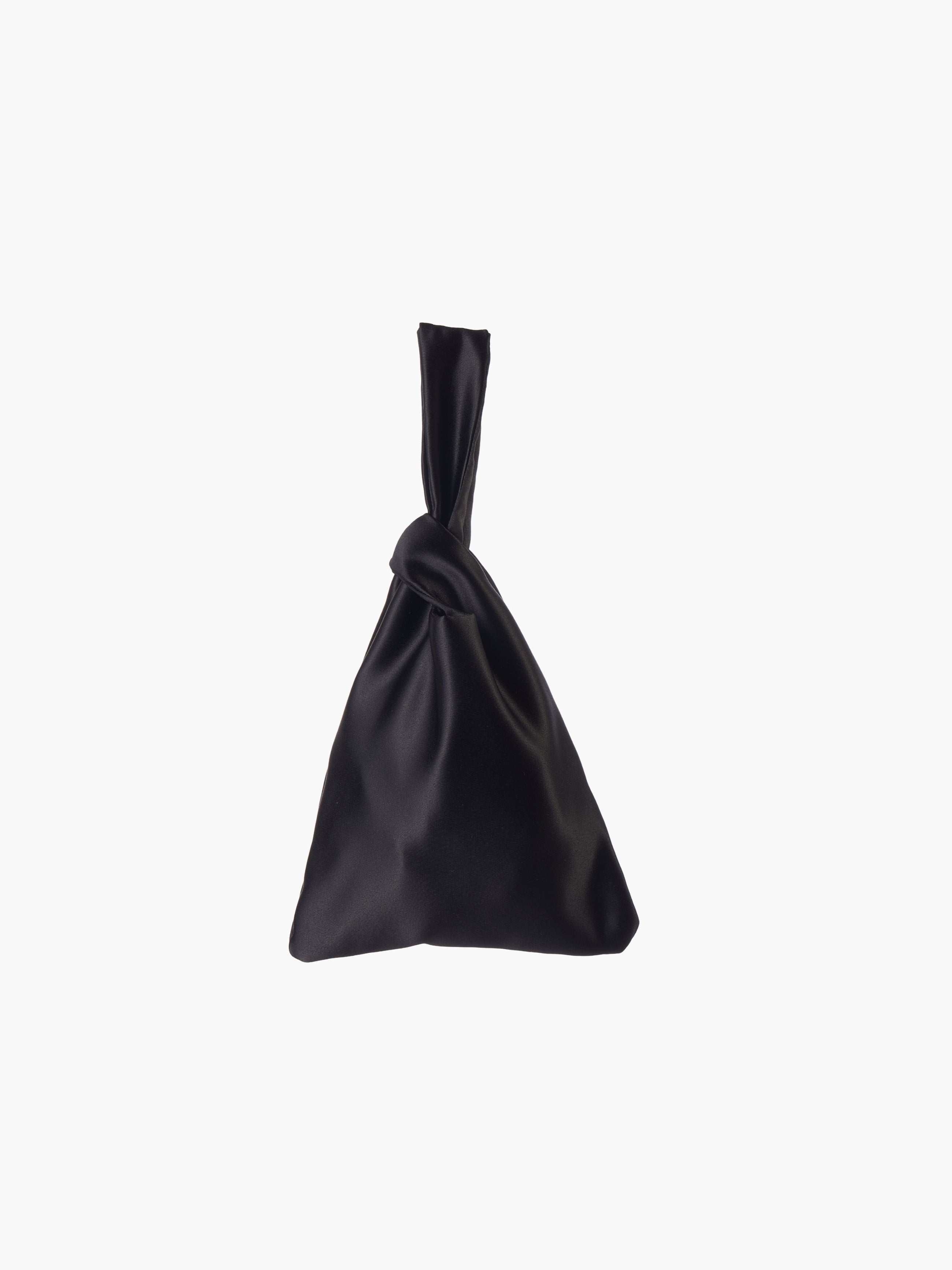 Black satin knot bag against a plain white background. The elegant bag has a twisted handle and sleek, glossy fabric, exuding a chic, minimalist style.