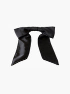 Black satin hair bow clip accessory on a white background