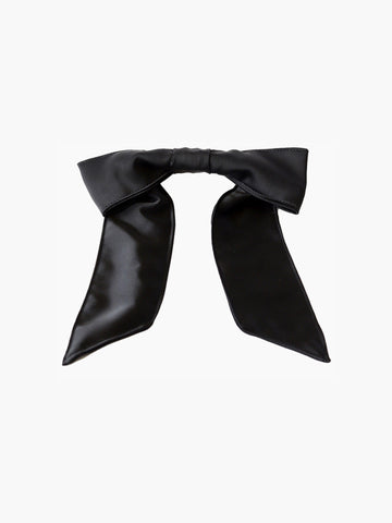 Black satin hair bow clip accessory on a white background