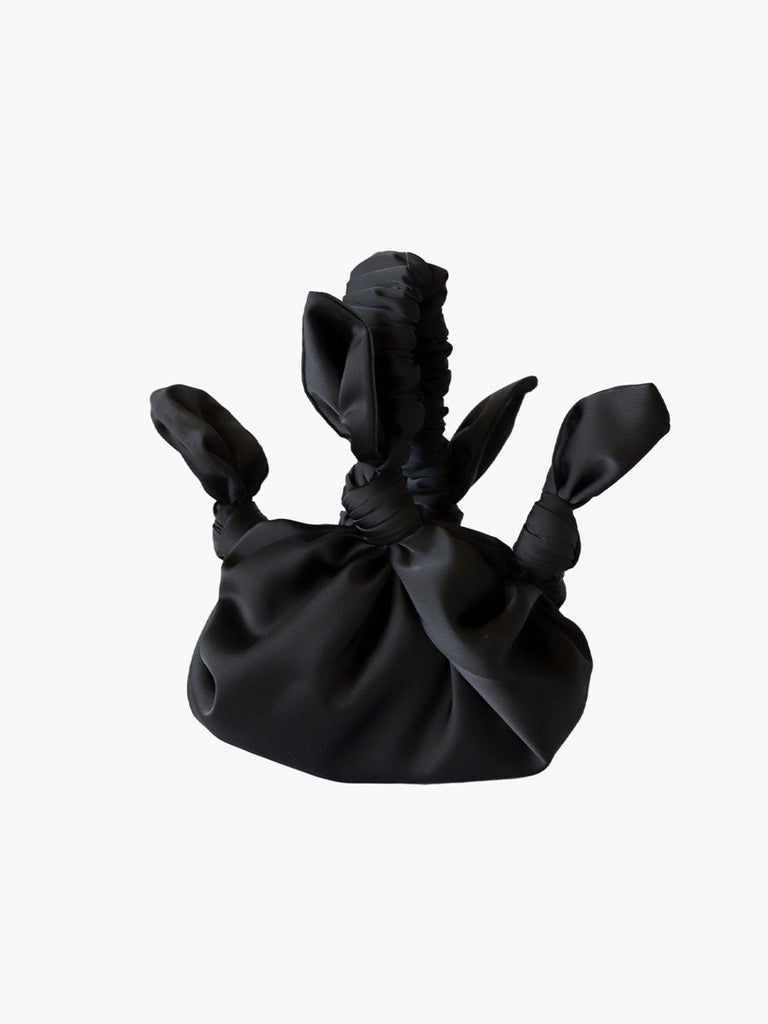 Black satin knotted fabric bag on a white background