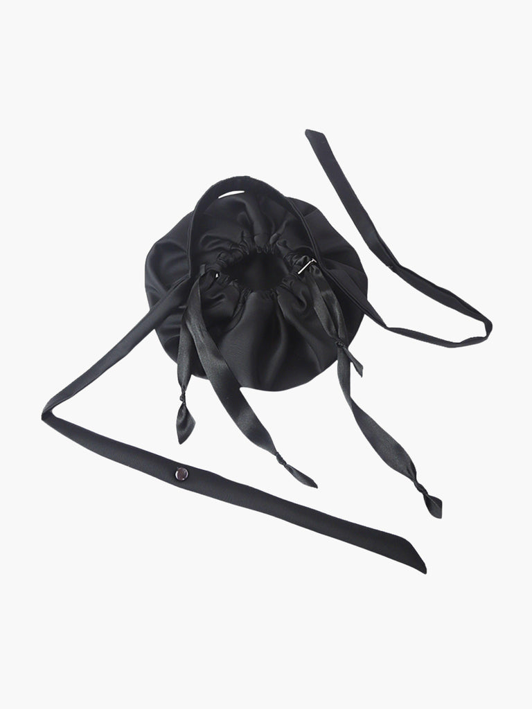 Black satin puffball drawstring bag with a long straps, set on a white background