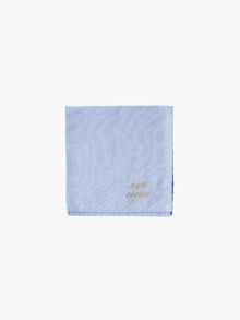 A blue cotton embroidered square handkerchief, embroidered with initials and the date in gold. 