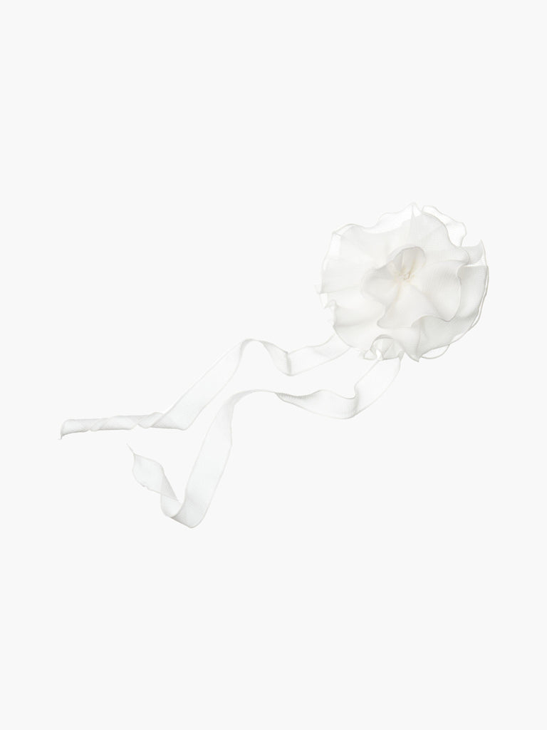 White floral chiffon corsage accessory with long tails, set on a white background