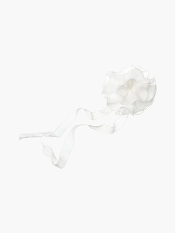 White floral chiffon corsage accessory with long tails, set on a white background