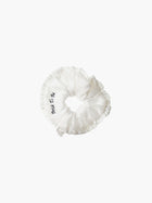 Ivory ruffled scrunchie with black embroidery that reads 'bride to be' on a white background