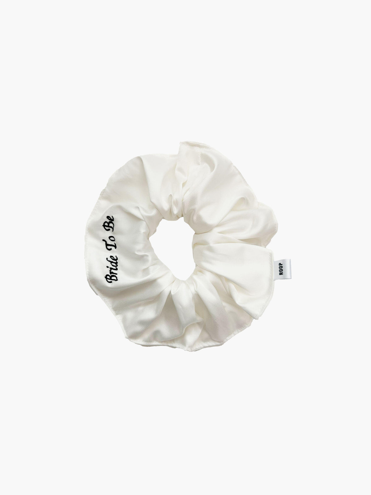 Ivory bamboo silk satin scrunchie with 'Bride To Be' embroidered in black on a white background.