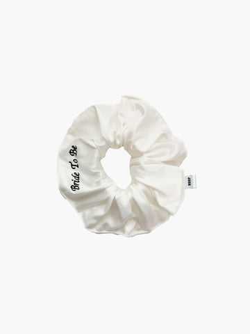 Ivory bamboo silk satin scrunchie with 'Bride To Be' embroidered in black on a white background.