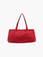 A sleek burgundy handbag with a minimalist design, featuring a rectangular shape and two thin straps. The tone is elegant and versatile against a plain white background.