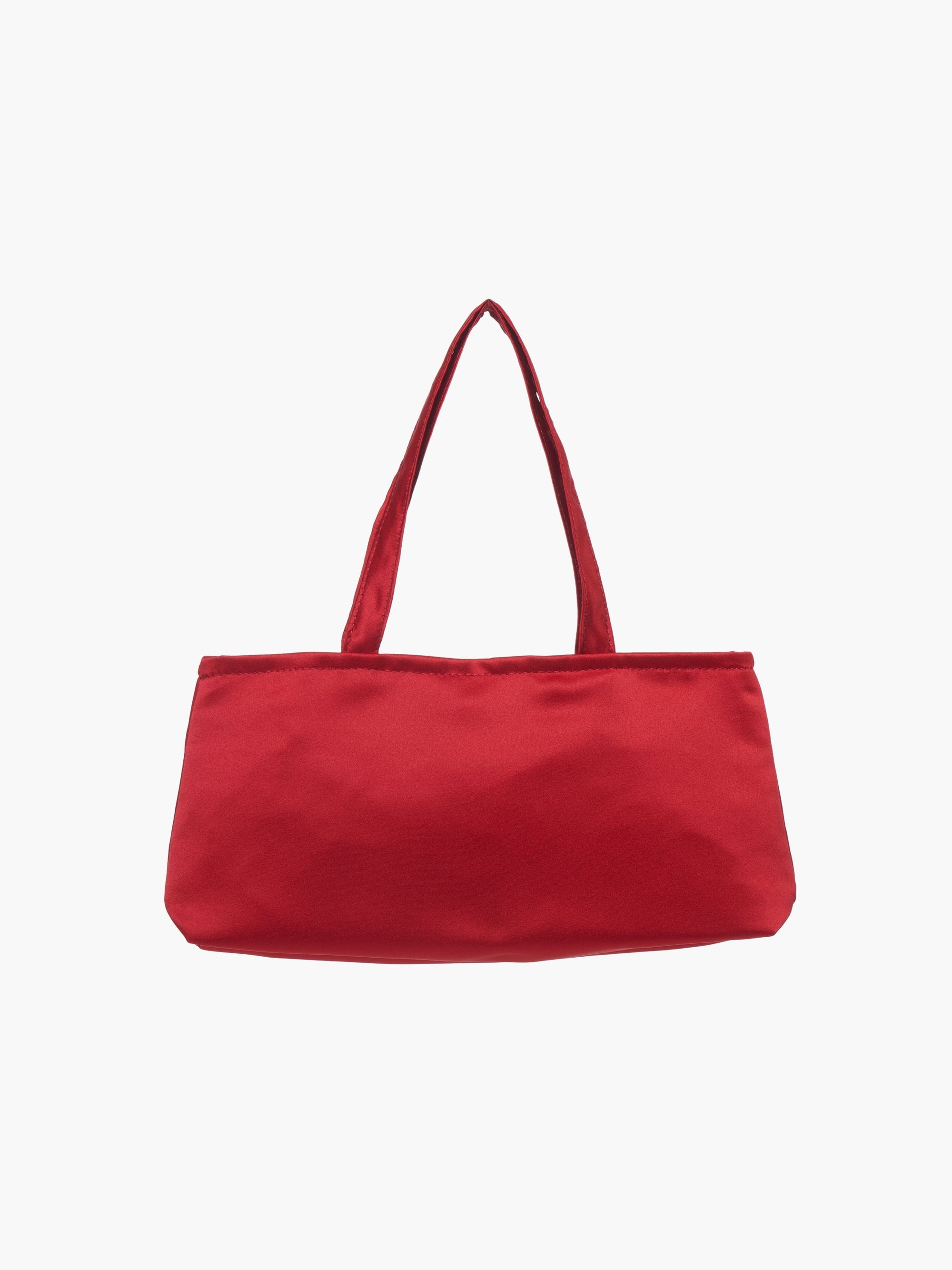 A sleek burgundy handbag with a minimalist design, featuring a rectangular shape and two thin straps. The tone is elegant and versatile against a plain white background.