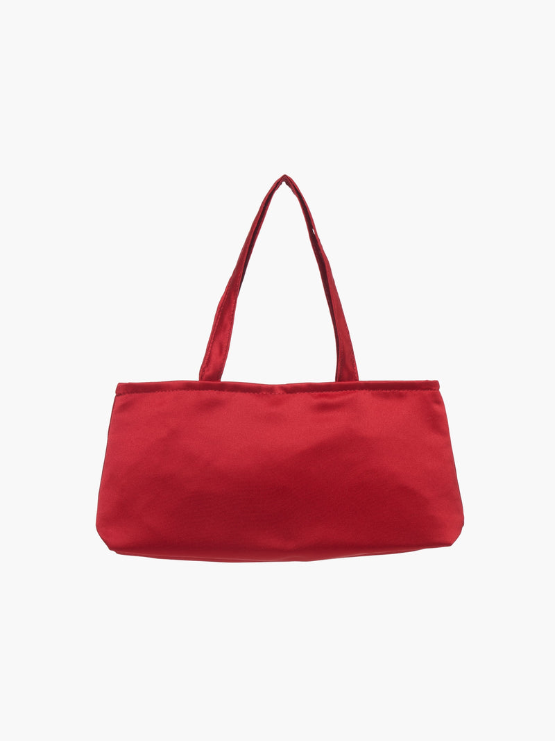 A sleek burgundy handbag with a minimalist design, featuring a rectangular shape and two thin straps. The tone is elegant and versatile against a plain white background.