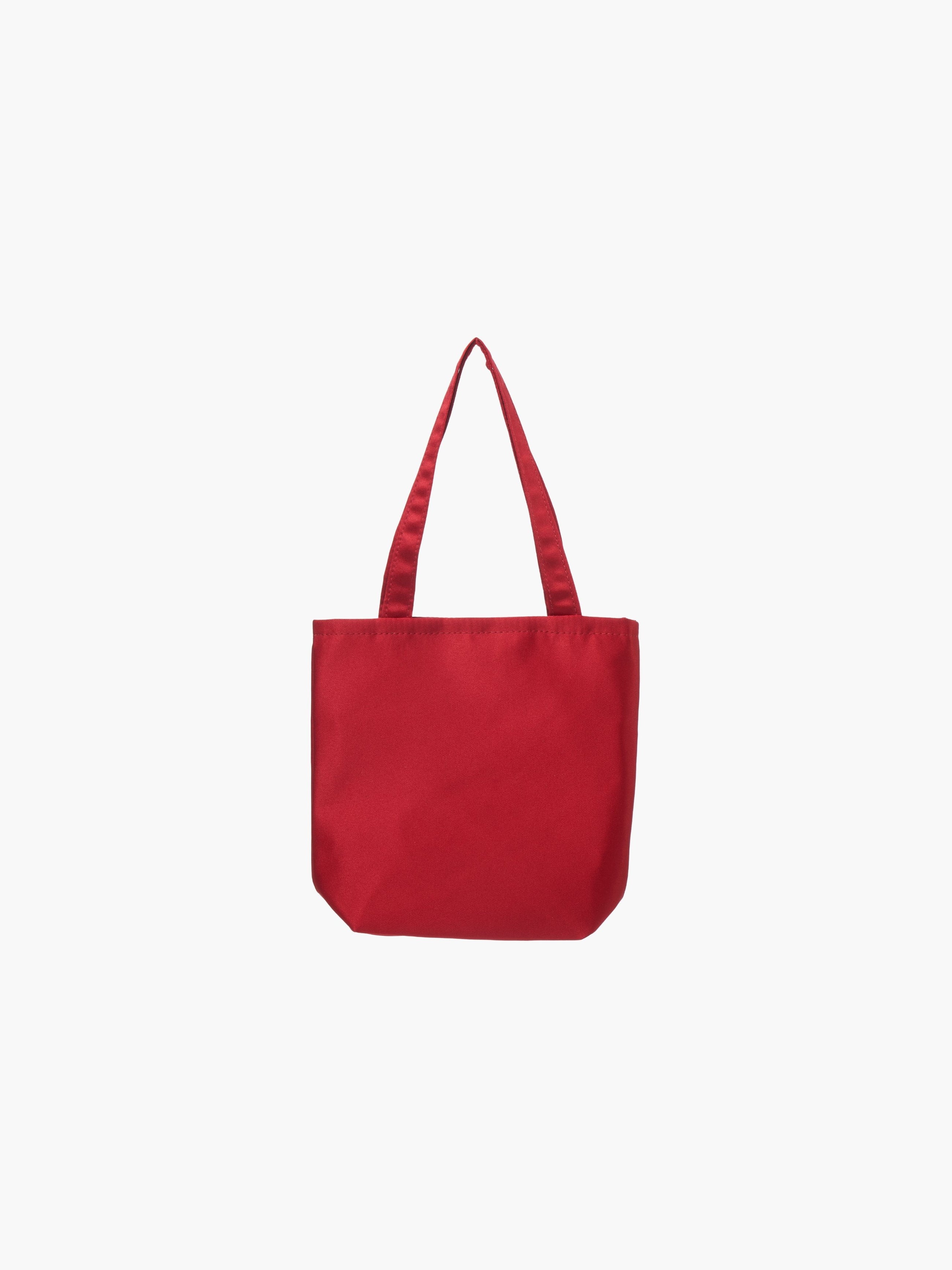A burgundy satin tote bag with. It features matching handles, set against a plain white background.