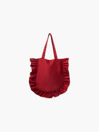 A burgundy satin tote bag with ruffled edges on the sides and bottom. It features matching handles, set against a plain white background.