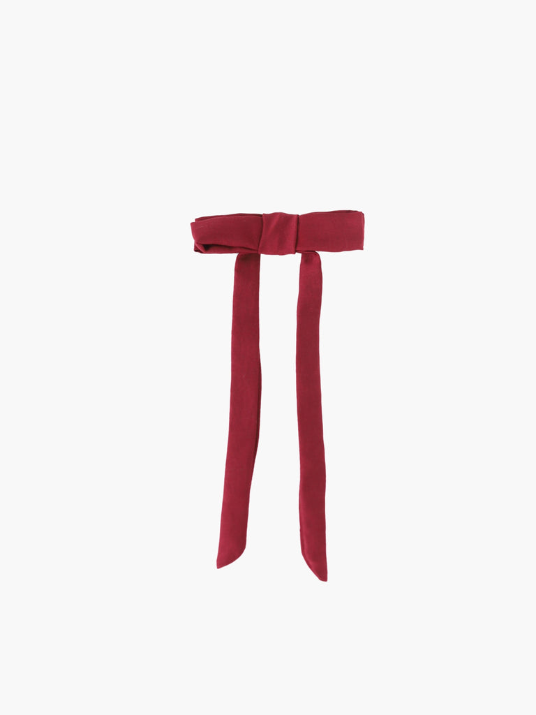 burgundy satin bow hair clip on a white background