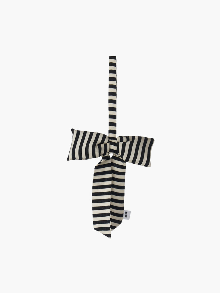 A black and ivory striped padded fabric bow featuring a loop for hanging. The bow exudes a playful and decorative feel.