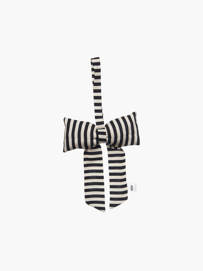 A black and ivory striped padded fabric bow featuring a loop for hanging. The bow exudes a playful and decorative feel.