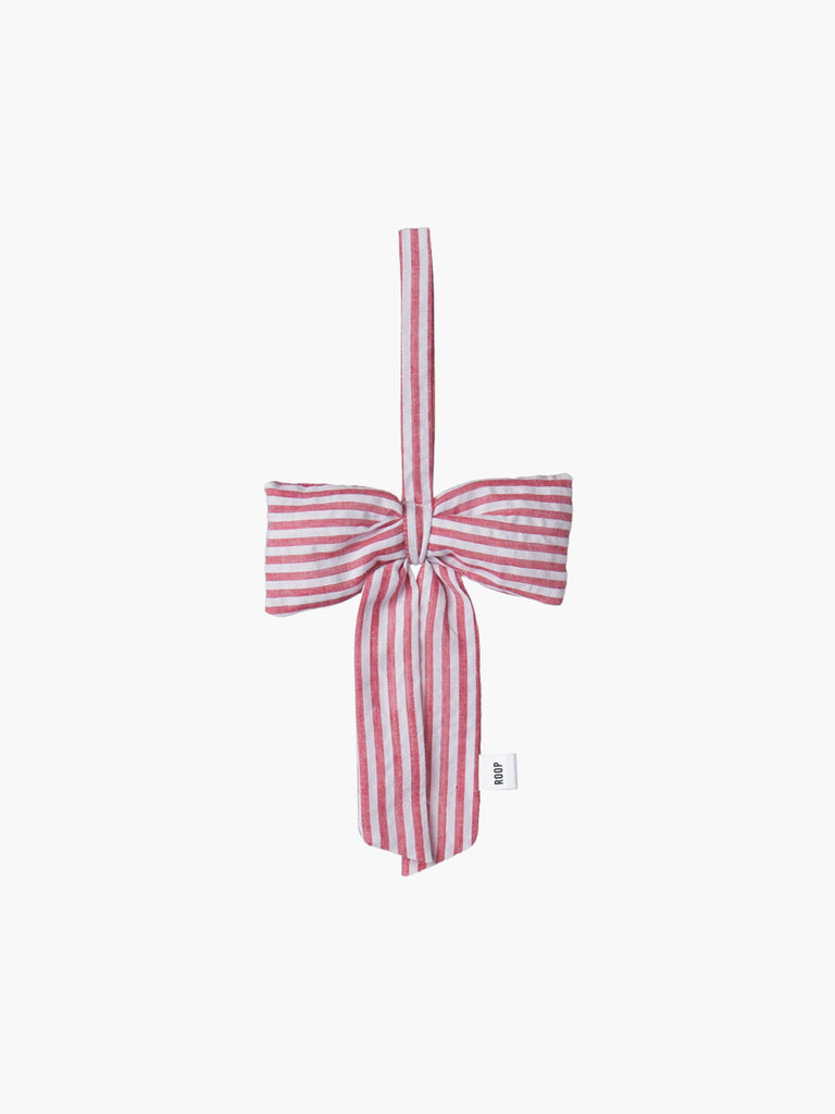 Red and white striped padded bow decoration on a white background