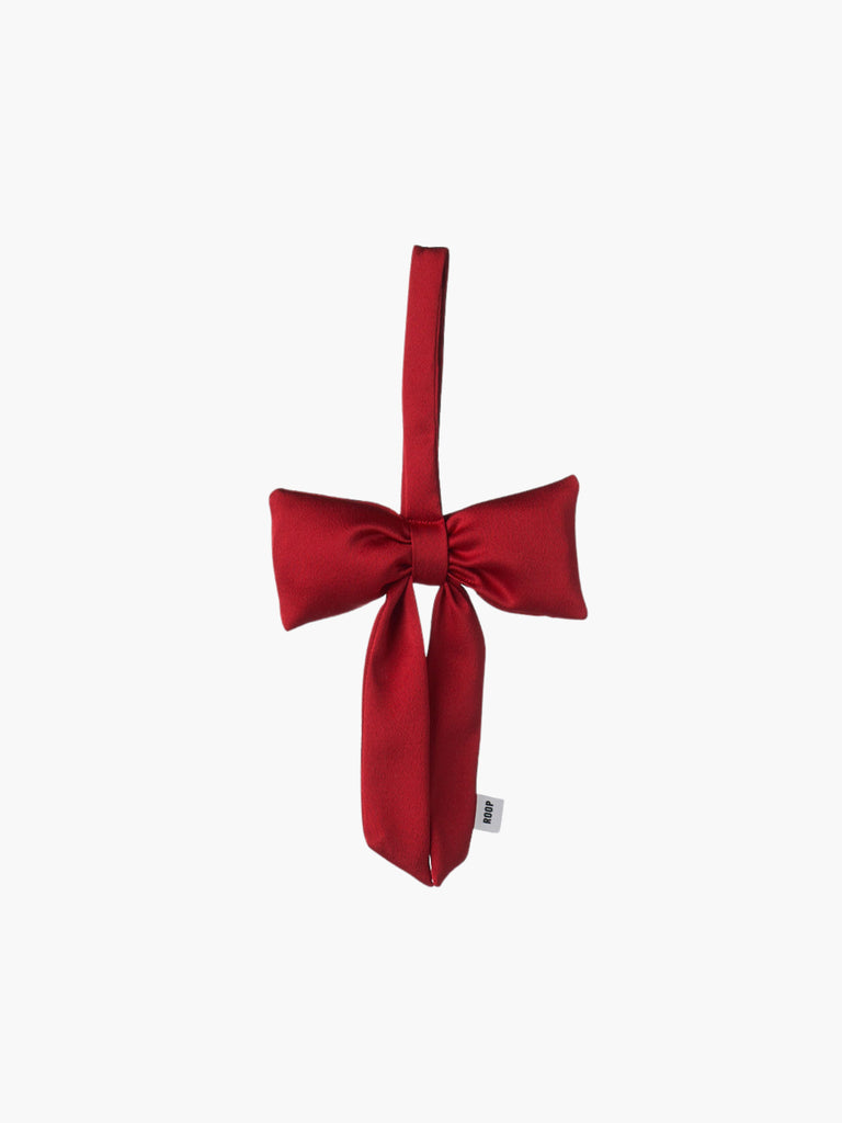 A red satin padded fabric bow featuring a loop for hanging. The bow exudes a playful and decorative feel.