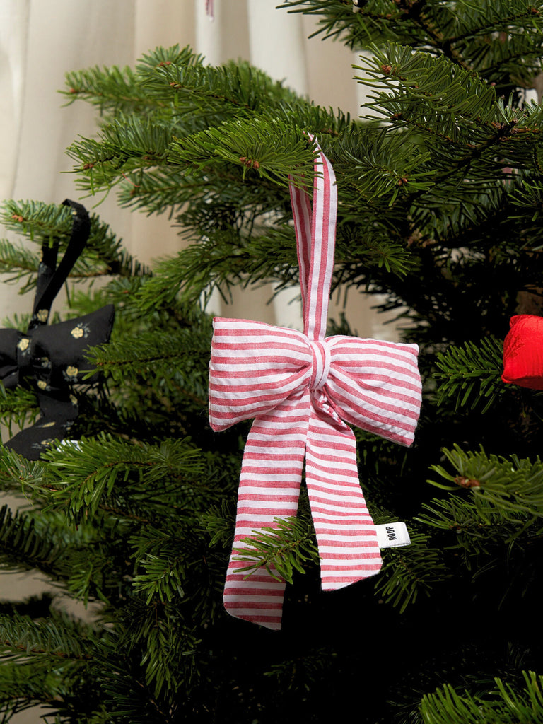 red and white striped bow decoration on a Christmas tree