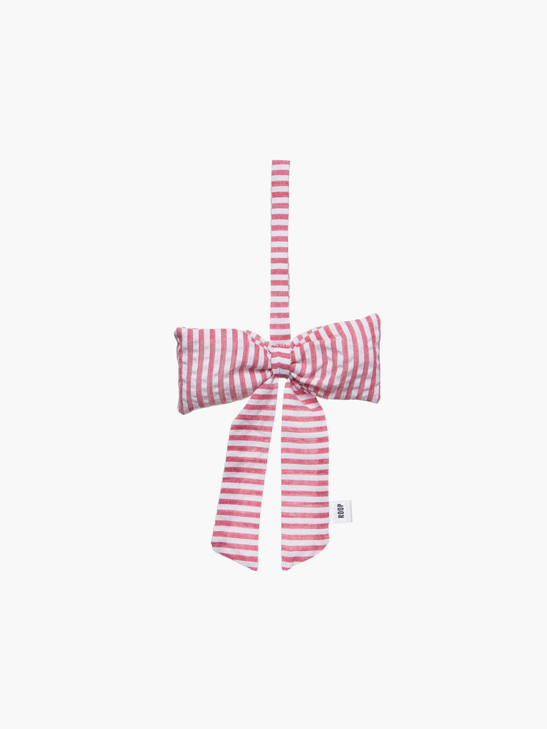 A red and ivory white padded fabric bow featuring a loop for hanging. The bow exudes a playful and decorative feel.