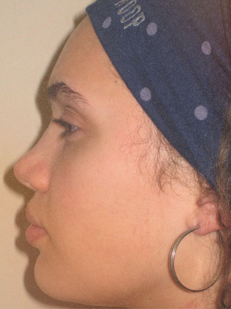 Side profile of a person wearing a blue headband with light blue polka dots and ROOP branding.
