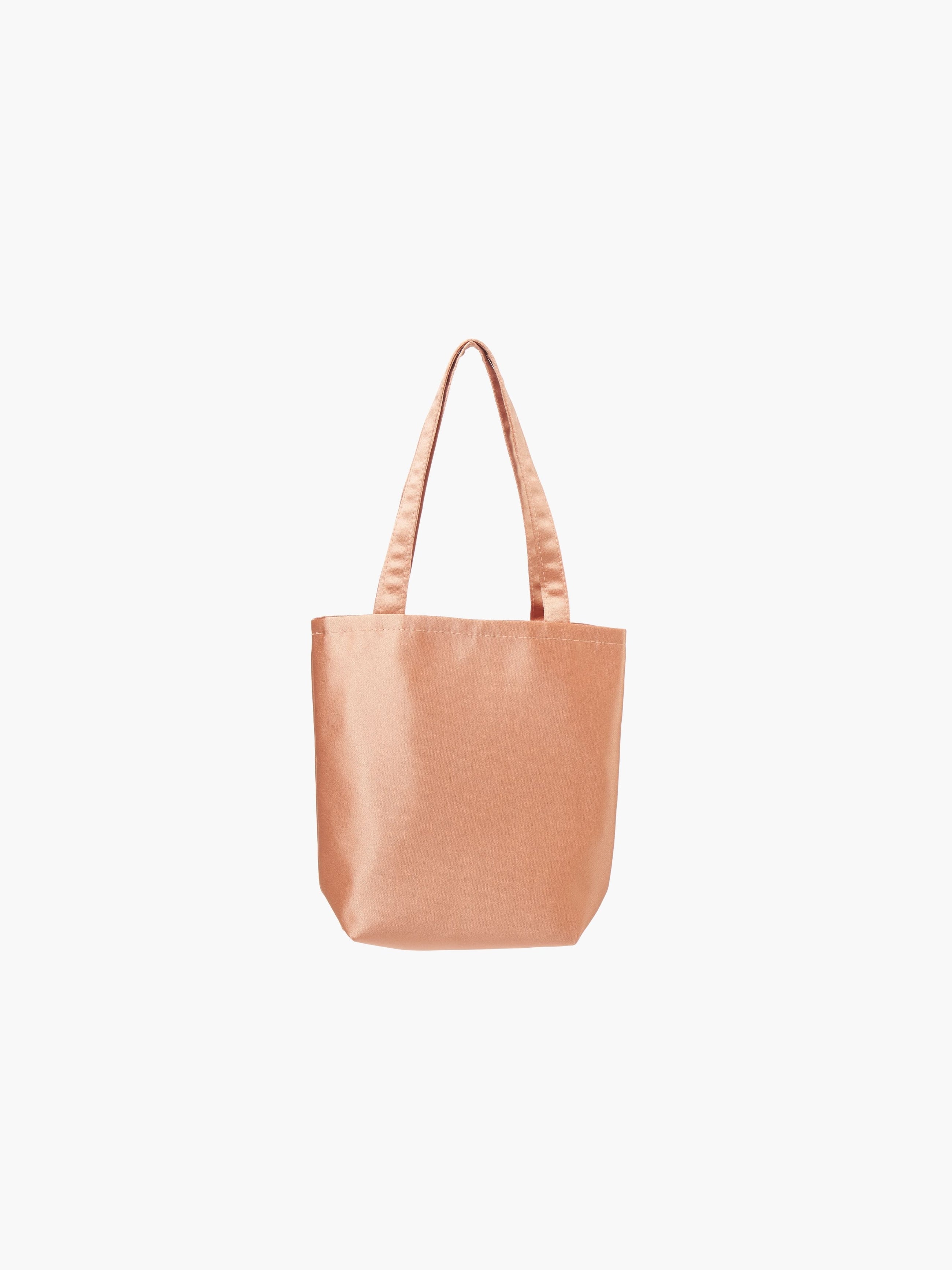 A rose gold satin tote bag with. It features matching handles, set against a plain white background.