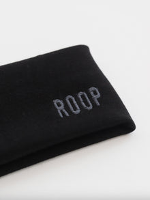 Black stretch headband with 'ROOP' embroidery on a white background