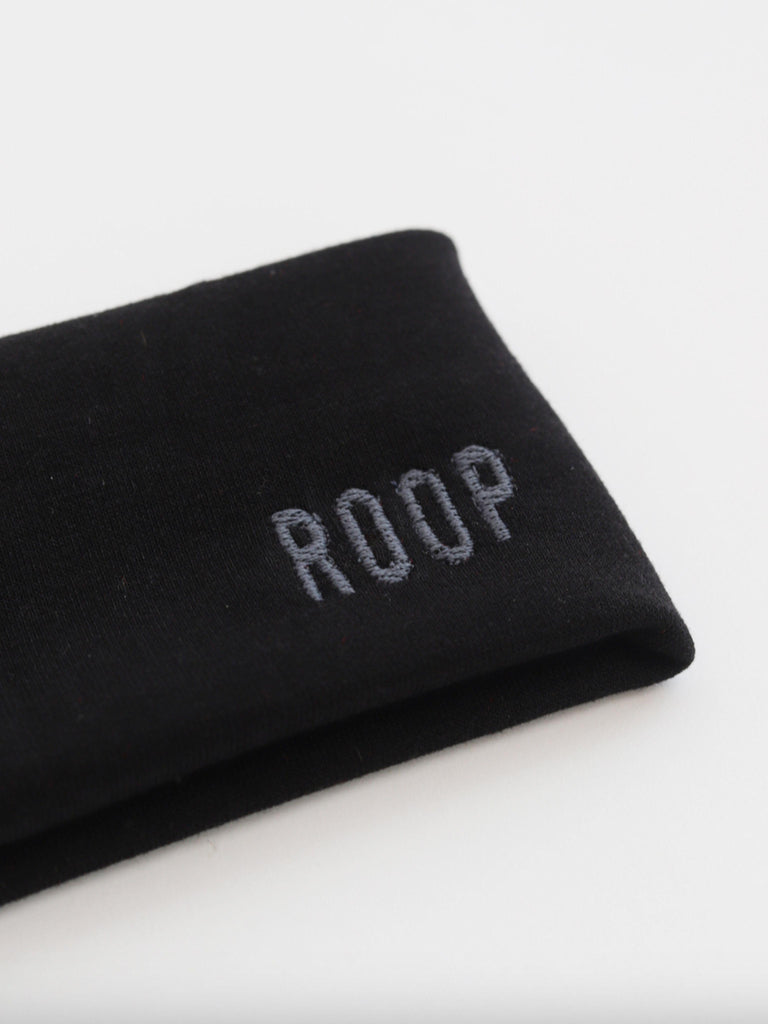 Black stretch headband with 'ROOP' embroidery on a white background