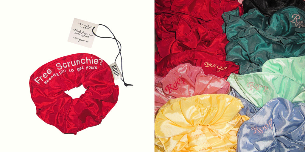 Red scrunchie with promotional text and a display of colorful scrunchies.