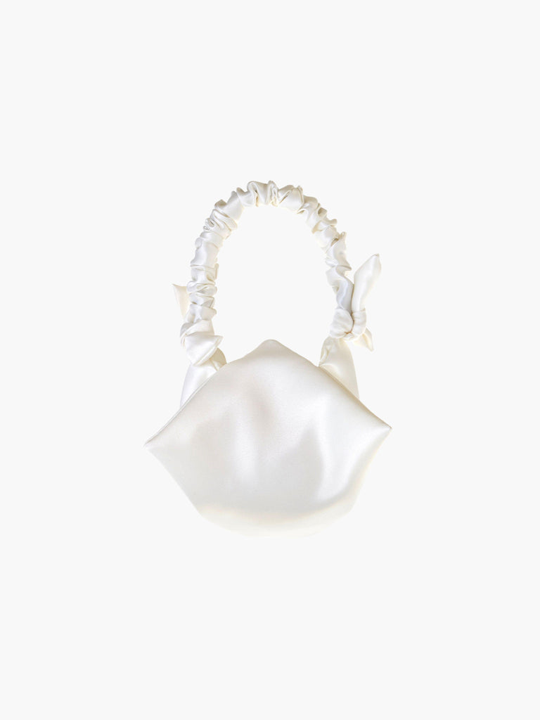 Ivory satin ruched handle handbag with decorative bows, set on a white background