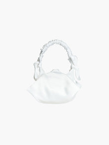 white satin ruched handle handbag with decorative bows, set on a white background