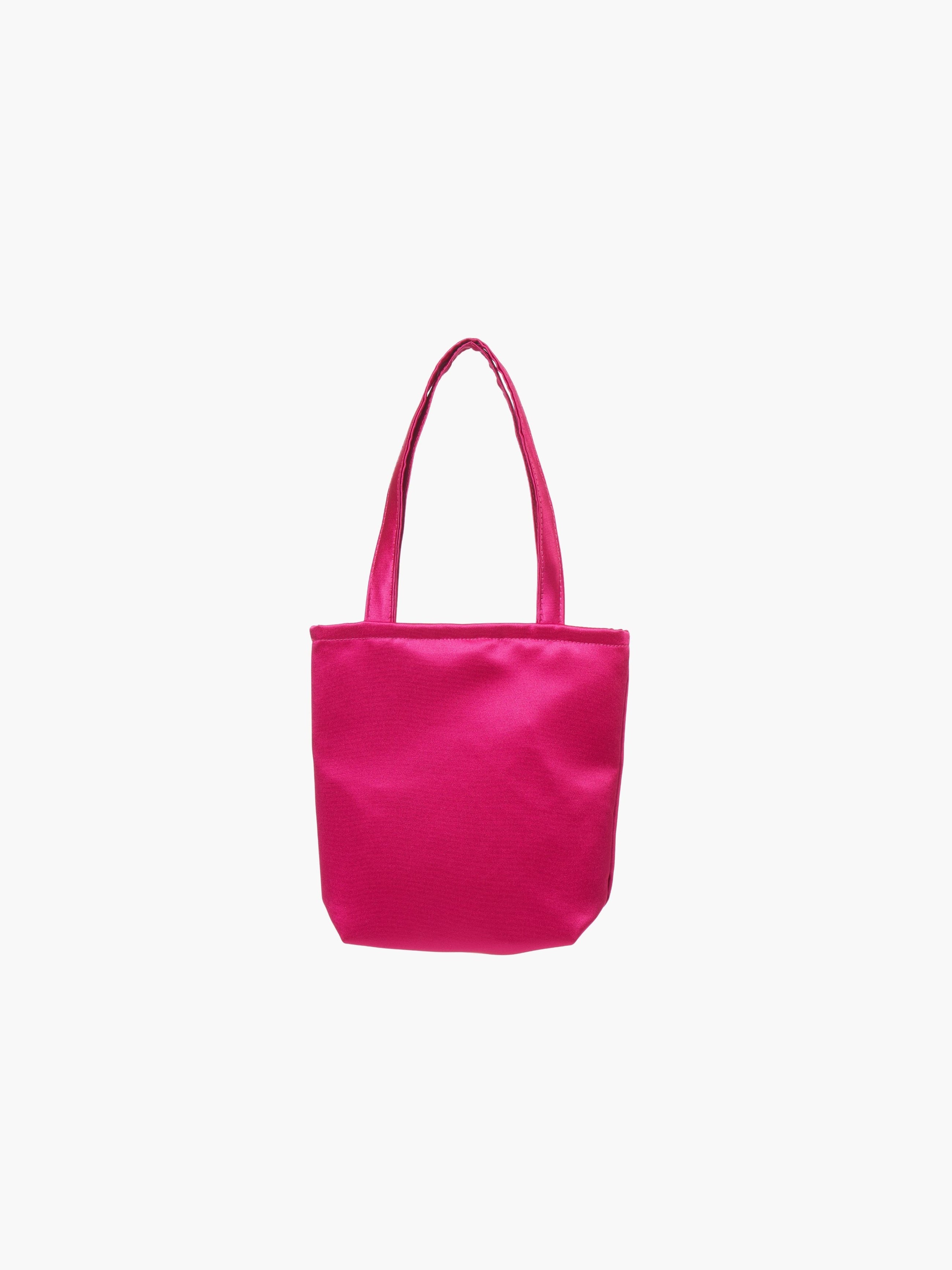 A fuchsia satin tote bag with. It features matching handles, set against a plain white background.