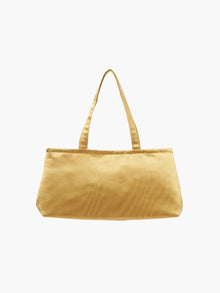 A sleek gold handbag with a minimalist design, featuring a rectangular shape and two thin straps. The tone is elegant and versatile against a plain white background.