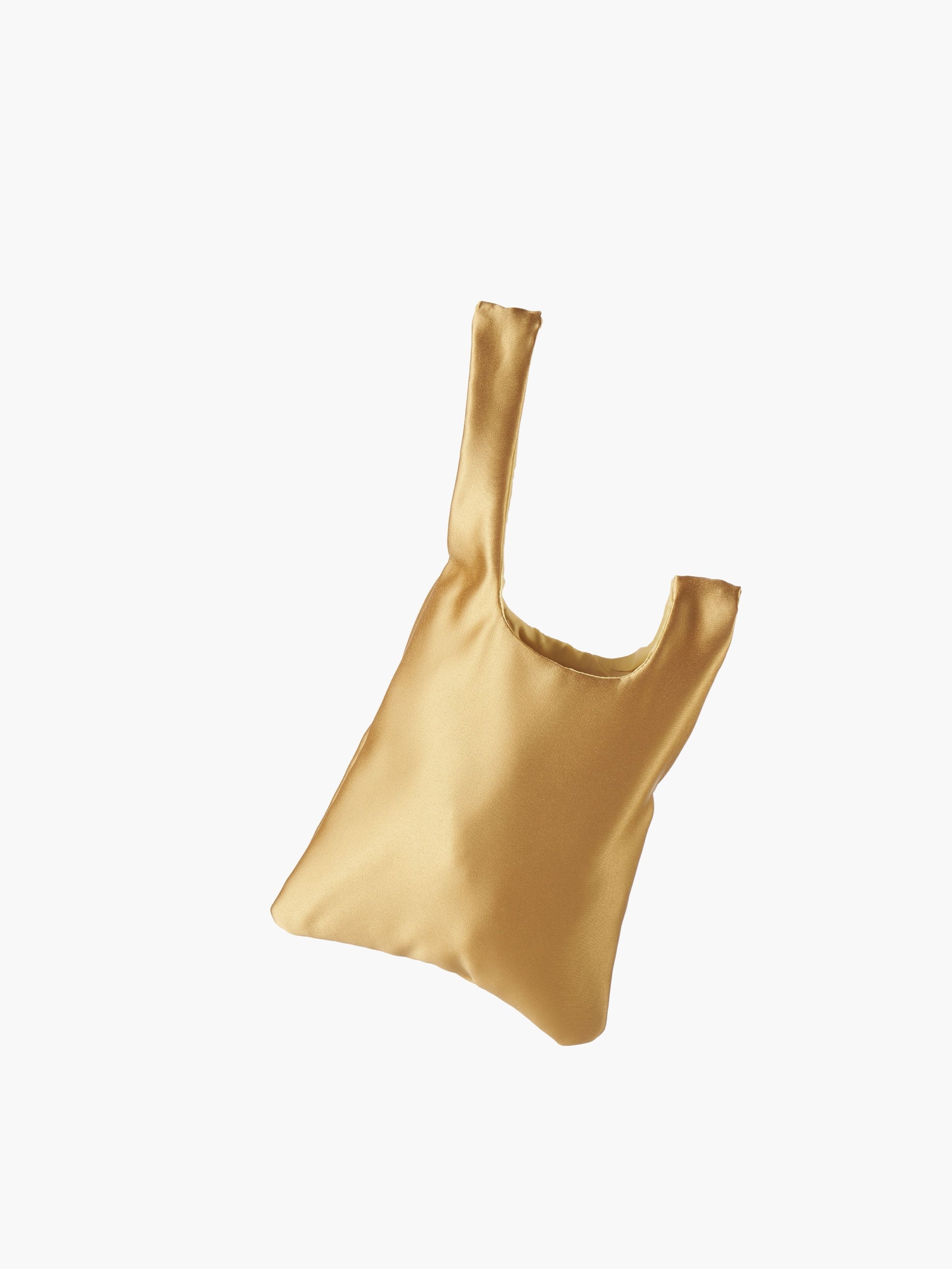 Gold satin knot bag against a plain white background. The elegant bag has a twisted handle and sleek, glossy fabric, exuding a chic, minimalist style.