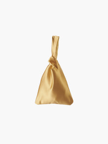 Gold satin knot bag against a plain white background. The elegant bag has a twisted handle and sleek, glossy fabric, exuding a chic, minimalist style.