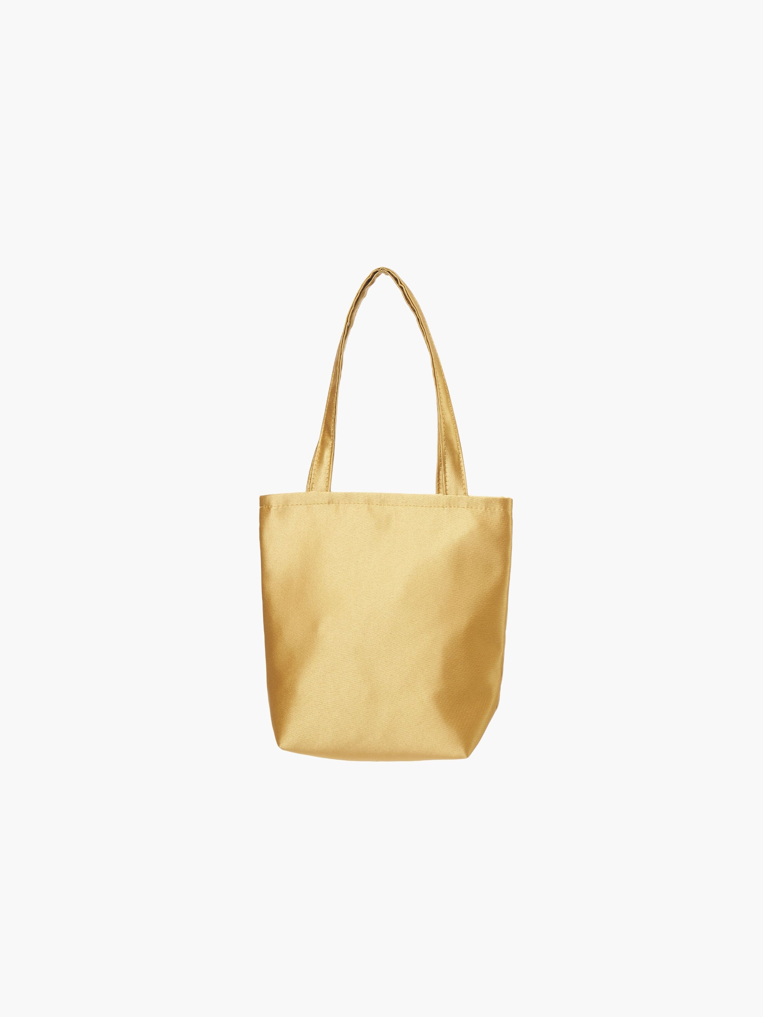 A gold satin tote bag. It features matching handles, set against a plain white background.