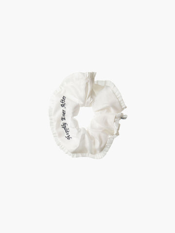 Ivory ruffled scrunchie with black embroidery that reads 'happily ever after' on a white background