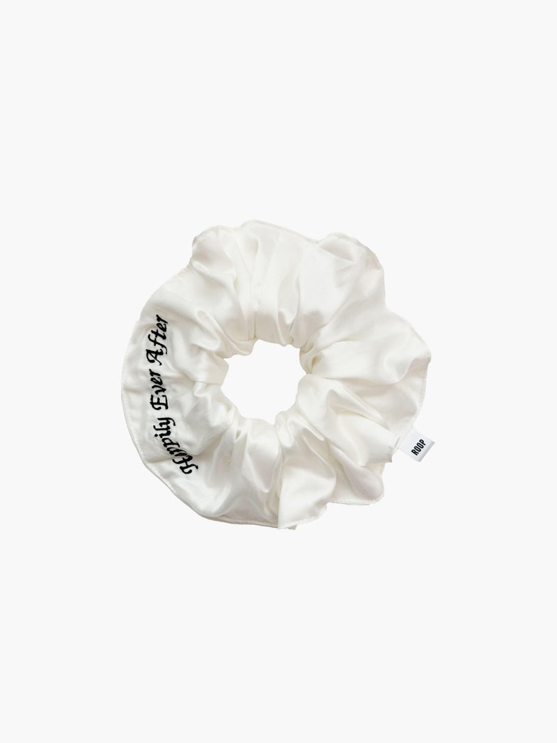 Ivory bamboo silk satin scrunchie with 'Happily Ever After' embroidered in black on a white background.