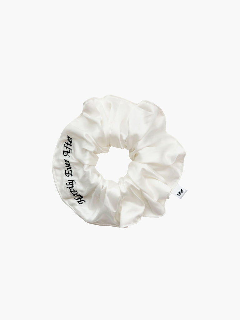 Ivory bamboo silk satin scrunchie with 'Happily Ever After' embroidered in black on a white background.