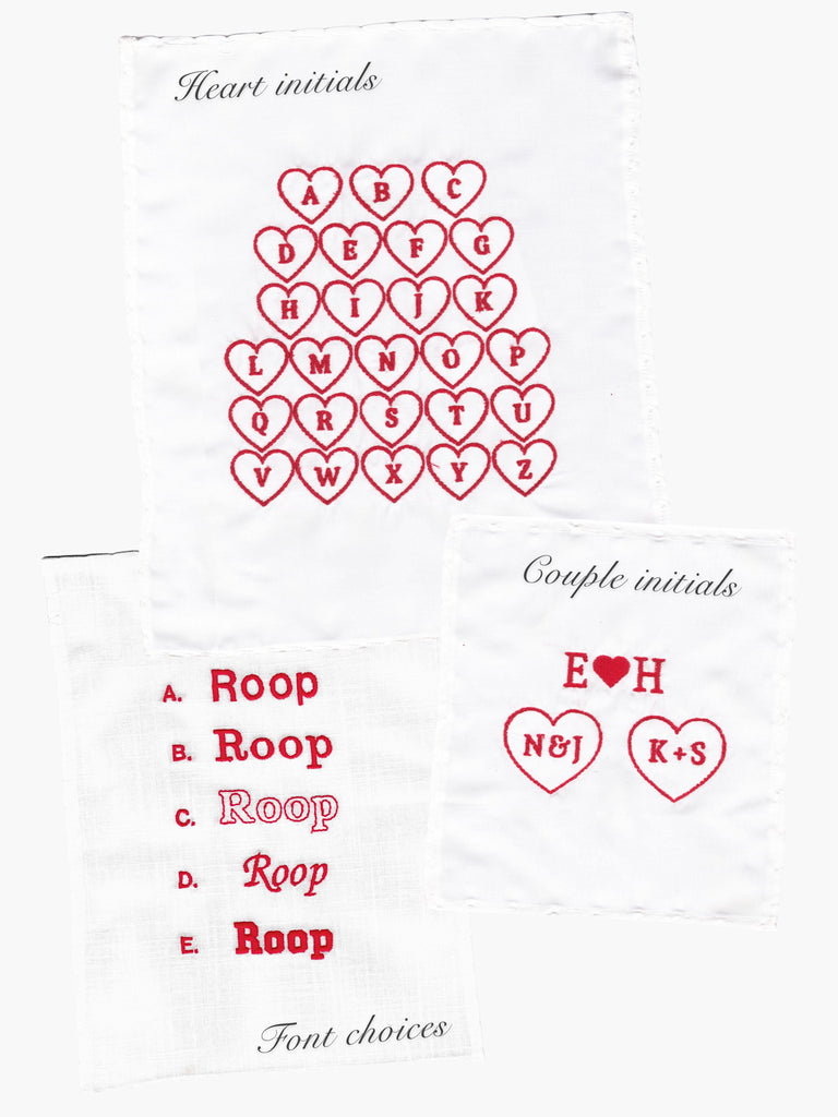 embroidery sample charts of fonts and heart initials in red thread on white pieces of fabric, set on a white background.