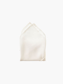 An ivory folded pocket square made from silk, set against a white background.